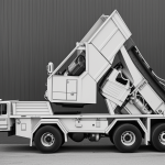 A simple black and white line art of a dump truck, ideal for coloring enthusiasts, featuring clean outlines and blank fill areas for a creative coloring experience.