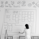 Simple black and white vector line art of a teacher writing on a chalkboard, designed as a children's printable coloring page with bold outlines and no fill.
